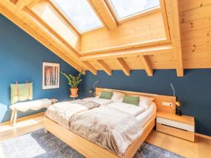 a bedroom with a bed and a wooden ceiling at Drei Berge Top 7 in Saalbach Hinterglemm