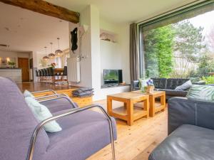 a living room with a couch and a table at Landhuis Duinzicht in Callantsoog