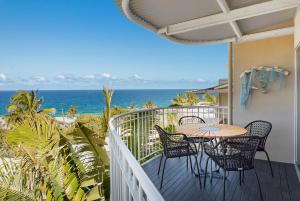 a balcony with a table and chairs and the ocean at Unit 9 Fantastic Holiday Apartment in Sunshine Beach Stunning Views Opposite Beach Access in Sunshine Beach
