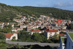 a town on a hill with a red circle at Apartments by the sea Vis - 2457 in Vis