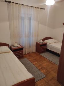 a room with two beds and two tables and a window at Apartments by the sea Vis - 2457 in Vis