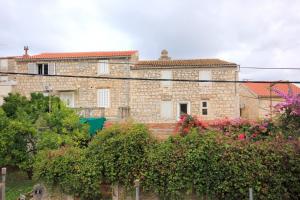 a large brick building with flowers in front of it at Apartments by the sea Vis - 2457 in Vis +8 photos
