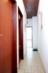 a hallway with two doors and a tile floor at Apartments by the sea Vis - 2457 in Vis