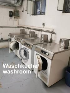 a kitchen with a washing machine and a sink at Wohnen mit Panoramablick in Kornwestheim