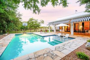 a swimming pool in the backyard of a house at Luxury Golf Course Private Retreat with Heated Swimming Pool in Horseshoe Bay
