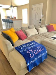 a couch with colorful pillows on it in a living room at Cheerful 3 Bdrm space, 2 bath!. You gotta love it! in Oklahoma City
