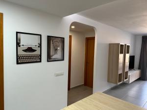 a white room with two pictures on a wall at Bilbao House in Adeje +27 photos