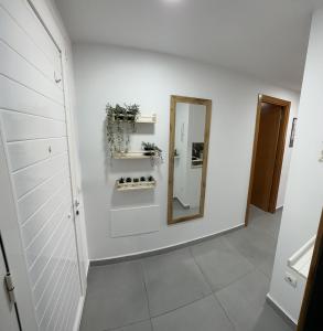 a hallway with a mirror on a white wall at Bilbao House in Adeje