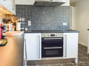 a kitchen with a stove and a counter top at Top Deck in Gorran Haven