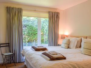 a bedroom with a large bed with a large window at Top Deck in Gorran Haven