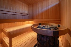 a sauna with a tub with rocks in it at 海野宿一棟貸し宿 上州屋 Unnojuku Joshuya in Tomi