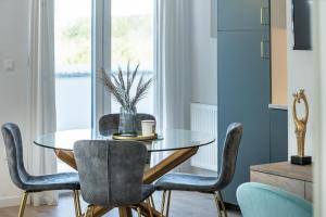 a dining room with a glass table and chairs at Apartments and rooms with parking space Grabovac, Plitvice - 21931 in Rakovica +11 photos