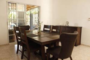a dining room with a wooden table and chairs at Relax House in Concepción de La Vega