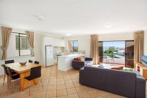 a living room with a couch and a table at Noosa International Resort in Noosa Heads