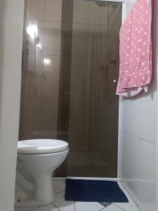 a bathroom with a shower with a toilet and a towel at Locação Casa Residencial Guarujá - Alta Temporada in Guarujá