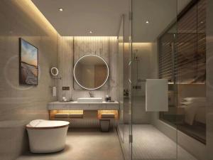 a bathroom with a sink and a mirror at Vienna International Hotel - Changsha Yuelu Lugu Hi-Tech Zone in Changsha