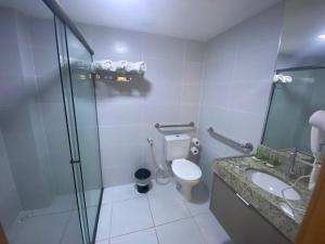 a bathroom with a shower and a toilet and a sink at Guest Manaíra Apart Hotel in João Pessoa