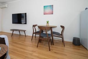 a dining room table and chairs in a room at 24 Burswood Comfort Short Walk To Crown & Optus! - Superhog verification Required in Perth