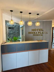 a hotel reception counter in a lobby with lights at Serra Plaza Premium in Serrinha