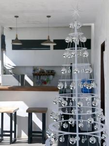 a white christmas tree with silver ornaments on it at 1949 Dreamy Home in Panglao Island