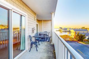 a balcony with a table and chairs and a view of the water at Captiva Bay 202 in Ocean City