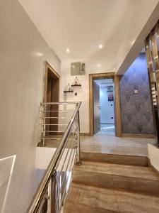 a hallway with a staircase and a door in a house at Luxury 4 Bdr Home in the city in Abuja