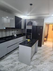 a kitchen with a black and white counter top at Luxury 4 Bdr Home in the city in Abuja