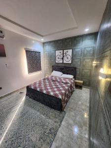 a bedroom with a bed with a bike on the wall at Luxury 4 Bdr Home in the city in Abuja