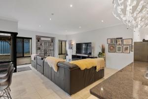 a living room with a couch with yellow pillows on it at 13 Family Home In Morley Sleeps 6 Comfortably in Perth