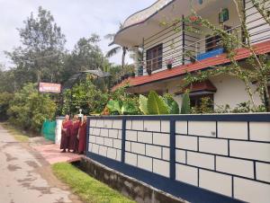 a group of people standing in front of a building at Coorg peacock feathers home stay in Kushālnagar