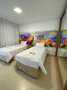 Ένα ή περισσότερα κρεβάτια σε δωμάτιο στο CAPIVARI ECORESORT