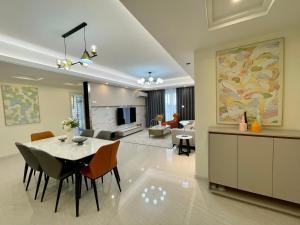a dining room and living room with a table and chairs at SKY 31 Luxurious Condominium in Phnom Penh