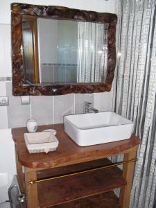 a bathroom with a sink and a mirror at Moulin De Chez Renaud in Sousmoulins