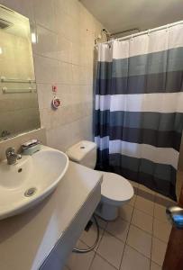 a bathroom with a sink and a toilet and a shower at One Bedroom Condo with fast wifi at Eastwood Lafayette tower Quezon city in Manila
