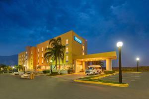 a hotel with a van parked in front of it at City Express by Marriott Monterrey Santa Catarina in Monterrey