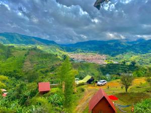 a view of a village with mountains in the background at Cabañas Villa Loe in Jardin +3 photos
