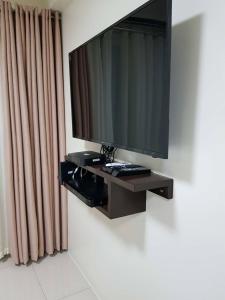a flat screen tv hanging on a wall at Studio unit at The Breeze Residence in Manila