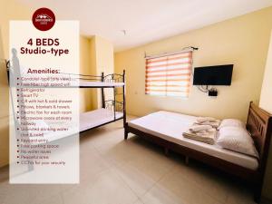 a bedroom with two bunk beds and a sign for a bed studio type at Zukiya Residences Baguio in Baguio