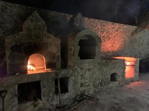 an old stone building with a fireplace at night at La Casa Del Mexicano in Celestún
