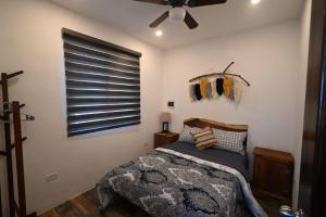 a bedroom with a bed and a ceiling fan at La Casa Del Mexicano in Celestún