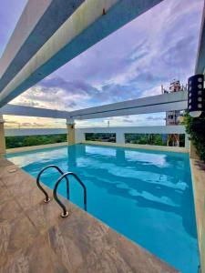 a swimming pool on the roof of a building at Smart Condominium Official in Cagayan de Oro