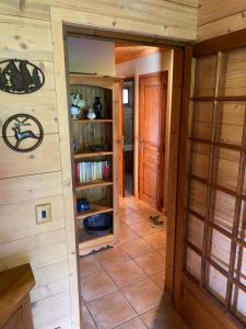 a hallway in a log cabin with a door and shelves at Apartment with balcony and panoramic view between sky and mountains in Megève
