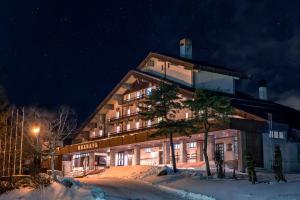 a hotel building in the snow at night at Madarao Kogen Hotel in Iiyama