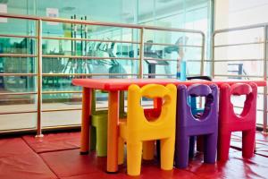 a colorful table and chairs sitting next to a window at Kacha Resort & Spa, Koh Chang in Ko Chang