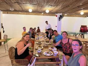 a group of people sitting at a table eating at On Board Panglao Beach Hostel & Resort in Dao
