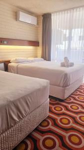 Cama o camas de una habitación en Indian Ocean Hotel