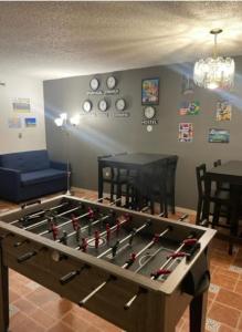 a game room with a large table with baseball bats at Beds & Sheets DOWNTOWN in Miami