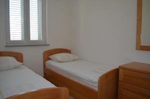 Giường trong phòng chung tại Apartments Buljan