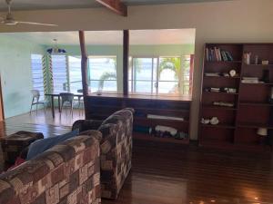 a living room with a couch and a table at Limericks by the Sea in Savusavu