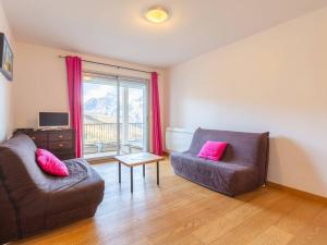 a living room with a couch and a table at Appartement Peyragudes, 2 pièces, 6 personnes - FR-1-695-42 in Germ